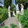 Stairs surrounded by statues leading to the Terrace of the Muses at Achilleion Palace in Corfu, Greece
